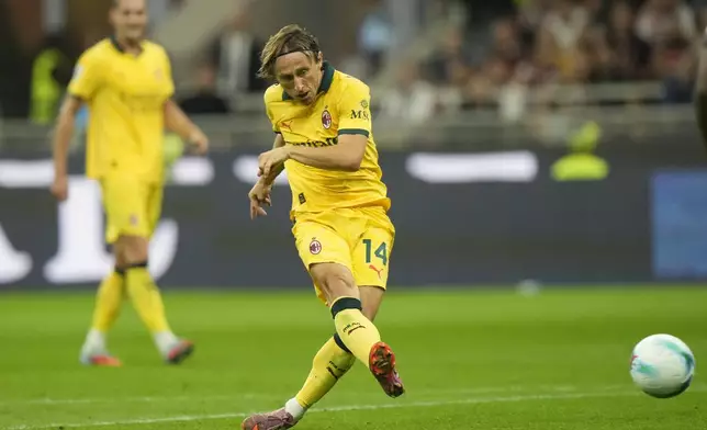AC Milan's Luka Modric scores his side's opening goal from a penalty kick during a Serie A soccer match between AC Milan and Bologna at San Siro stadium in Milan, Italy, Sunday, Sept. 14, 2025. (AP Photo/Luca Bruno)