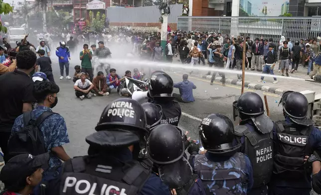 Riot police use a water cannon on protesters outside Parliament in Kathmandu, Nepal, Monday, Sept. 8, 2025. (AP Photo/Niranjan Shrestha)
