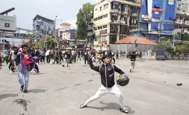 Protestors clash with the riot police outside the Parliament building in Kathmandu, Nepal, Monday, Sept. 8, 2025. (AP Photo/Niranjan Shrestha)