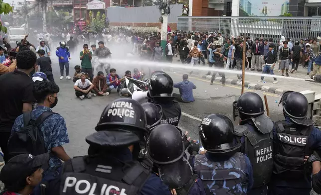 Riot police use water cannon on protesters during clashes outside parliament building in Kathmandu, Nepal, Monday, Sept. 8, 2025. (AP Photo/Niranjan Shrestha)