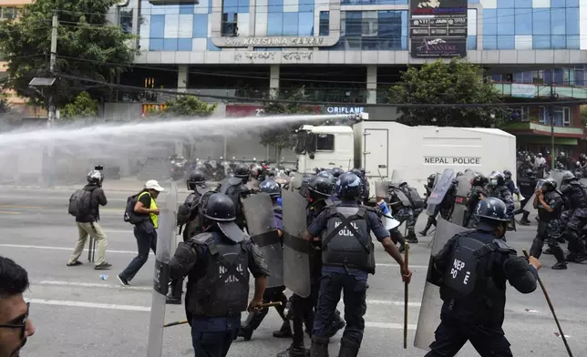 Riot police clash with the protesters outside the Parliament building in Kathmandu, Nepal, Monday, Sept. 8, 2025. (AP Photo/Niranjan Shrestha)