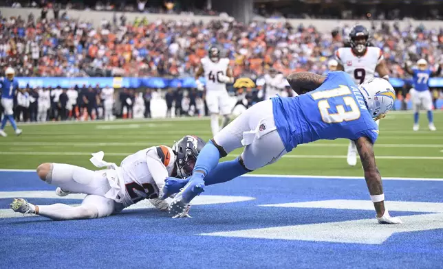 Los Angeles Chargers wide receiver Keenan Allen (13) catches a touchdown past Denver Broncos cornerback Riley Moss (21) during the second half an NFL football game Sunday, Sept. 21, 2025, in Inglewood, Calif. (AP Photo/Carrie Giordano)