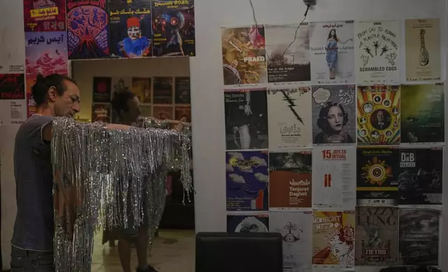 Alexandre Paulikevitch prepares his dress backstage before performing at a theatre in Beirut, Lebanon, Thursday, Sept. 11, 2025. (AP Photo/Hussein Malla)