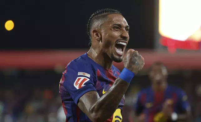 Barcelona's Raphinha celebrates scoring his side's 4th goal during a Spanish La Liga soccer match between FC Barcelona and Valencia at the Johan Cruyff stadium in Barcelona, Spain, Sunday, Sept. 14, 2025. (AP Photo/Joan Monfort)