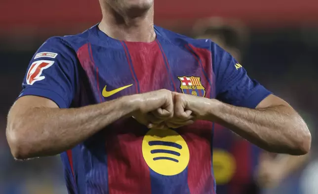 Barcelona's Robert Lewandowski celebrates scoring his side's 5th goal during a Spanish La Liga soccer match between FC Barcelona and Valencia at the Johan Cruyff stadium in Barcelona, Spain, Sunday, Sept. 14, 2025. (AP Photo/Joan Monfort)