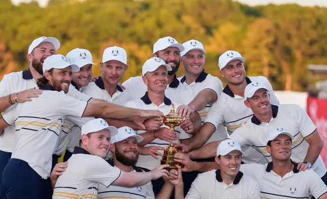 Europe poses with the trophy after winning the Ryder Cup golf tournament against the United States on the Bethpage Black golf course, Sunday, Sept. 28, 2025, in Farmingdale, N.Y. (AP Photo/Lindsey Wasson)