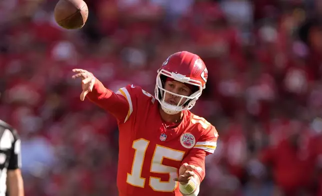 Kansas City Chiefs quarterback Patrick Mahomes (15) throws during the first half of an NFL football game against the Baltimore Ravens Sunday, Sept. 28, 2025, in Kansas City, Mo. (AP Photo/Charlie Riedel)