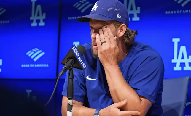 Los Angeles Dodgers pitcher Clayton Kershaw wipes his face as he speaks to the media after announcing his retirement at the end of the season prior to a baseball game against the San Francisco Giants Thursday, Sept. 18, 2025, in Los Angeles. (AP Photo/Mark J. Terrill)