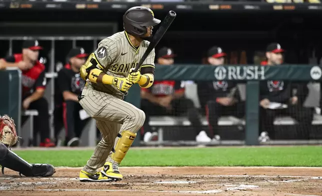 San Diego Padres' Luis Arraez hits an RBI single during the third inning of a baseball game against the Chicago White Sox, Friday, Sept. 19, 2025, in Chicago. (AP Photo/Matt Marton)
