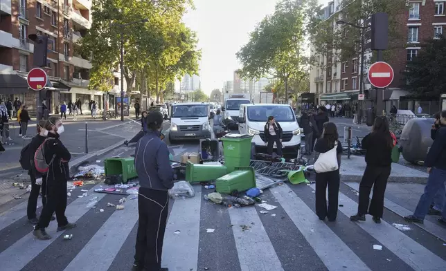 Protesters block a street during the "Bloquons Tout" (Block Everything) protest movement in Paris, Wednesday, Sept. 10, 2025. (AP Photo/Thibault Camus)