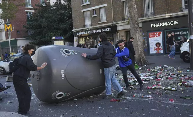 Protesters block a street during the "Bloquons Tout" (Block Everything) protest movement in Paris, Wednesday, Sept. 10, 2025. (AP Photo/Thibault Camus)