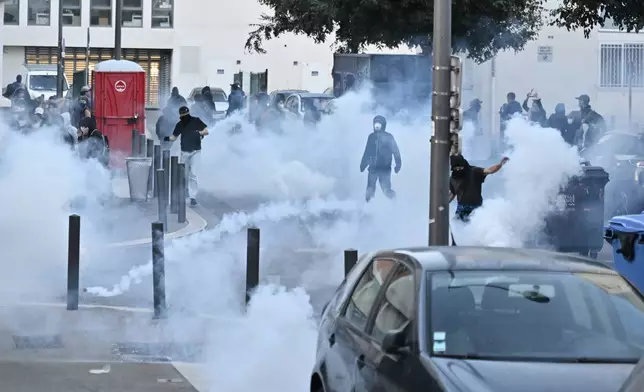 French police fire tear gas grenades to protesters during a gathering of the "Block Everything" movement in Marseille, south of France, Wednesday, Sept. 10, 2025. (AP Photo/Philippe Magoni)