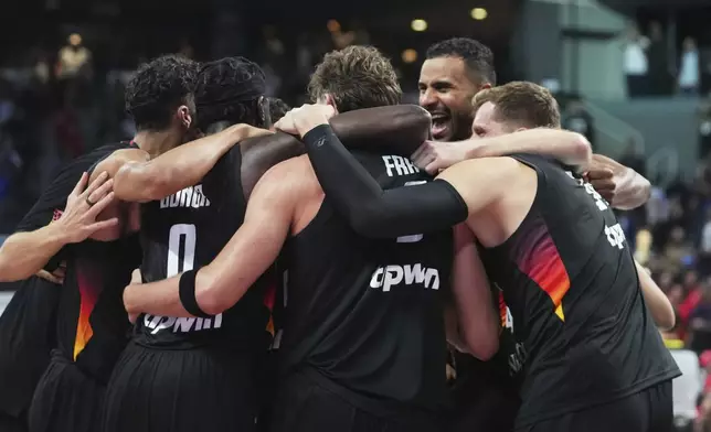 Germany players celebrate as they win the Eurobasket, European Basketball Championship final match between Turkey and Germany at the Riga Arena in Riga, Latvia, Sunday, Sept. 14, 2025. (AP Photo/Sergei Grits)