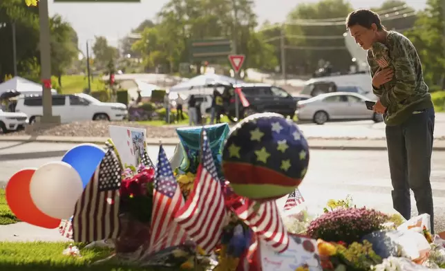 Wendy Lucas, a Utah Valley University student, looks at a memorial set up for Charlie Kirk at Utah Valley University in Orem, Utah, Friday, Sept. 12, 2025. (AP Photo/Lindsey Wasson)