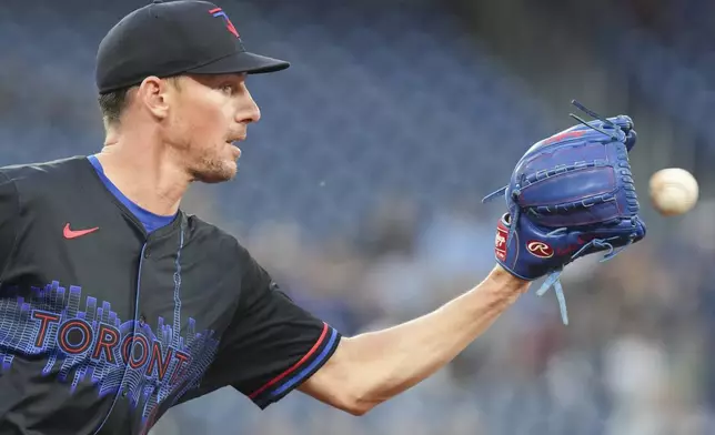 Toronto Blue Jays pitcher Chris Bassitt collects the ball to force out Baltimore Orioles' Gunnar Henderson at first base during first-inning baseball game action in Toronto, Friday, Sept. 12, 2025. (Chris Young/The Canadian Press via AP)