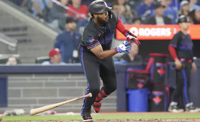 Toronto Blue Jays' Vladimir Guerrero Jr. doubles against the Baltimore Orioles during fifth inning MLB baseball action in Toronto, Friday Sept. 12, 2025. (Chris Young/The Canadian Press via AP)