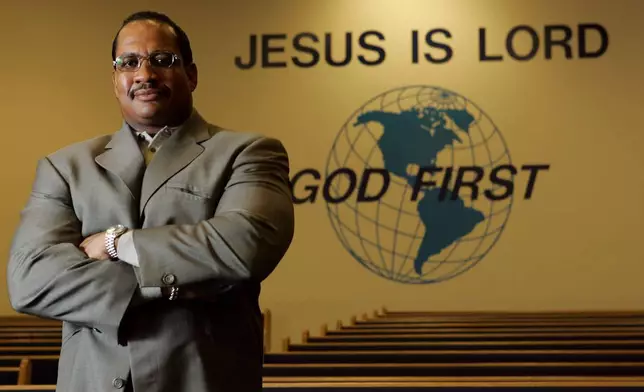 FILE - Pastor Patrick Wooden Sr. is seen in the sanctuary of the Upper Room Church of God in Christ on Dec. 9, 2004, in Raleigh, N.C. (AP Photo/Gerry Broome, File)