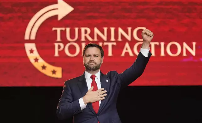 Vice President JD Vance holds his fist up as he leaves the stage after speaking at a memorial for conservative activist Charlie Kirk, Sunday, Sept. 21, 2025, at State Farm Stadium in Glendale, Ariz. (AP Photo/John Locher)
