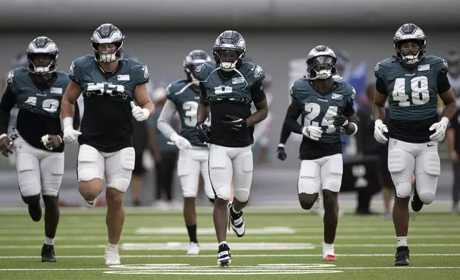 Philadelphia Eagles players warm up during indoor practice on Wednesday, Sept. 17, 2025, in Philadelphia. (Jose F. Moreno/The Philadelphia Inquirer via AP)