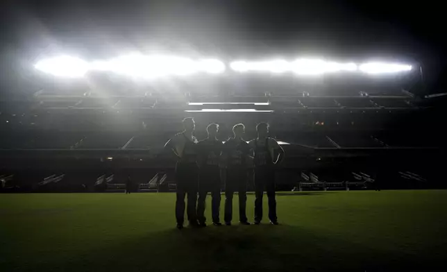 From left, Texas A&amp;M Yell Leaders Josh Brewton, Heath Flanagan, Luke Widener, and Luke Rollins stand inside Kyle Field during Midnight Yell in College Station, Texas on Saturday, August 30, 2025. (AP Photo/Sam Craft)