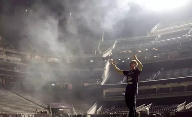 Texas A&amp;M Senior Yell Leader Heath Flanagan leads the crowd in Kyle Field in a chant during Midnight Yell in College Station, Texas on Saturday, August 30, 2025. (AP Photo/Sam Craft)