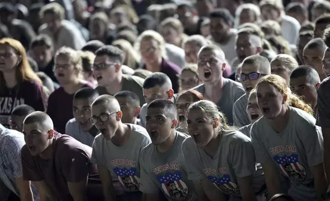 Members of the Texas A&amp;M Coprs of Cadets pratice yells during Midnight Yell in College Station, Texas on Saturday, August 30, 2025. (AP Photo/Sam Craft)