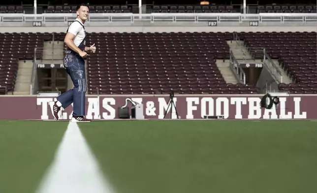 Texas A&amp;M Junior Yell Leader Josh Brewton walks back and forth in the center of Kyle Field before the start of Midnight Yell in College Station, Texas on Friday, Aug. 29, 2025. (AP Photo/Sam Craft)