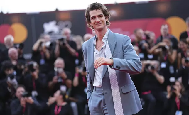 Andrew Garfield poses for photographers on the red carpet for the film 'After the Hunt' during the 82nd edition of the Venice Film Festival in Venice, Italy, on Friday, Aug. 29, 2025. (Photo by Scott A Garfitt/Invision/AP)