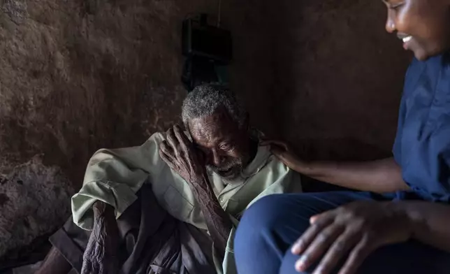 Field nurse Winnie Katwesigye, right, with Reach One Touch One Ministries, talks with Zaberia Kitwekyoma, who is about 90, after checking his blood pressure in Omunkore, a rural village in western Uganda, Tuesday, Nov. 19, 2024. For many older residents here, the only access to healthcare is the infrequent visits of the NGO's field nurse. (AP Photo/David Goldman)