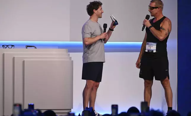 Meta CEO Mark Zuckerberg, left, talks with DJ Diplo during the company's Connect developer conference Wednesday, Sept. 17, 2025, in Menlo Park, Calif. (AP Photo/Nic Coury)