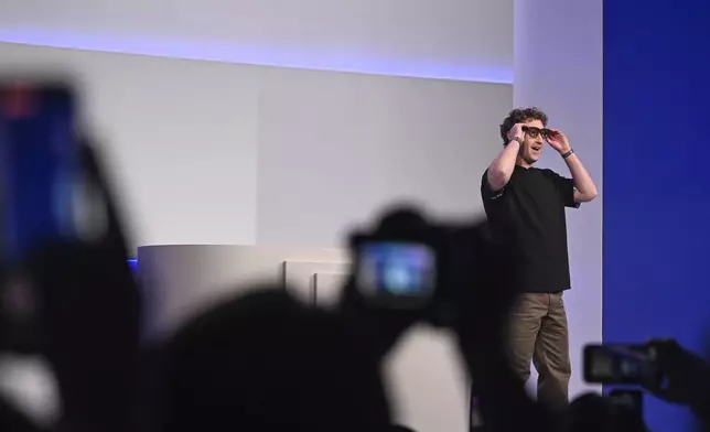 Meta CEO Mark Zuckerberg wears artificial intelligence-powered smart glasses as he speaks during the company's Connect developer conference Wednesday, Sept. 17, 2025, in Menlo Park, Calif. (AP Photo/Nic Coury)