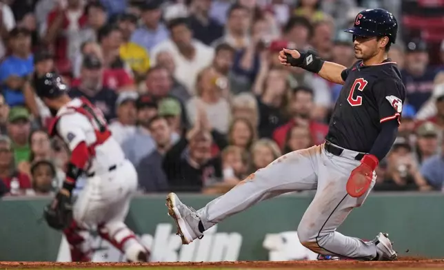 Cleveland Guardians' Steven Kwan, right, scores on a wild pitch as Boston Red Sox catcher Connor Wong chases the ball during the second inning of a baseball game at Fenway Park, Wednesday, Sept. 3, 2025, in Boston. (AP Photo/Charles Krupa)