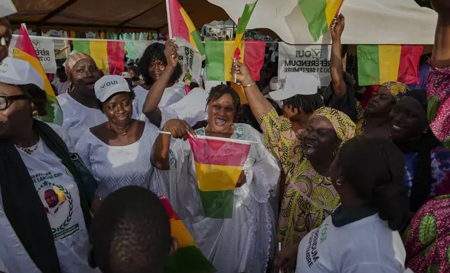 Supporters cheer and wave Guinean flags during a community rally ahead of the constitutional referendum in Conakry, Guinea, Monday, Sept. 15, 2025. (AP Photo/Misper Apawu)
