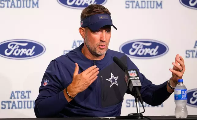 Dallas Cowboys head coach Brian Schottenheimer responds to questions during a news conference after an NFL football game against the Green Bay Packers Sunday, Sept. 28, 2025, in Arlington, Texas. (AP Photo/Jeffrey McWhorter)