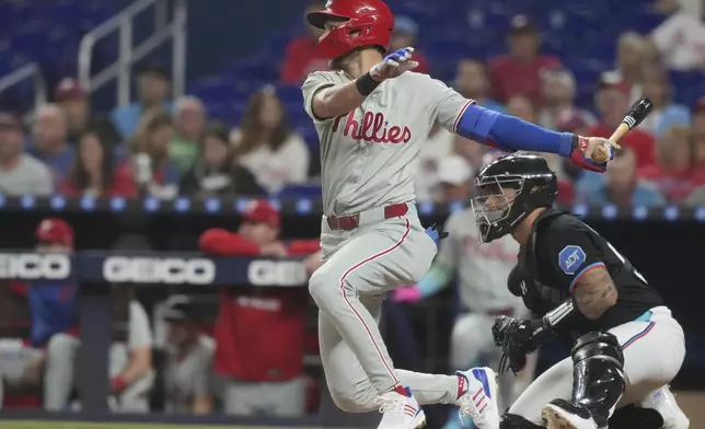 Philadelphia Phillies' Trea Turner hits a single during the first inning of a baseball game against the Miami Marlins Friday, Sept. 5, 2025, in Miami. (AP Photo/Marta Lavandier)