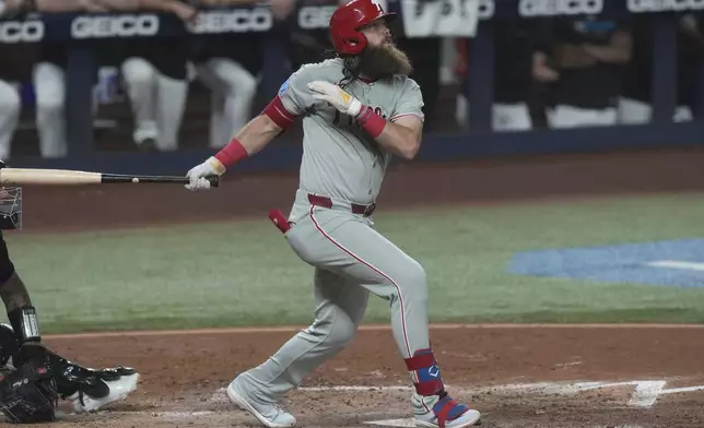 Philadelphia Phillies' Brandon Marsh hits a two-run home run during the fourth inning of a baseball game against the Miami Marlins Friday, Sept. 5, 2025, in Miami. (AP Photo/Marta Lavandier)