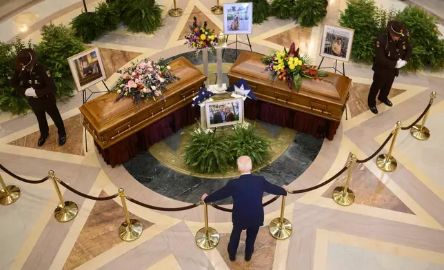 FILE - Former President Joe Biden pays his final respects to former Minnesota House Speaker Melissa Hortman, her husband, Mark, and their golden retriever, Gilbert, while they lie in state in the Minnesota Capitol rotunda in St. Paul, Friday, June 27, 2025. (Alex Kormann/Star Tribune via AP, File)