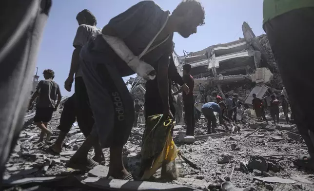 Palestinians inspect the damage after an Israeli army airstrike on a high-rise building in Gaza City, Friday, Sept. 5, 2025, after the Israeli army issued a prior warning. (AP Photo/Yousef Al Zanoun)