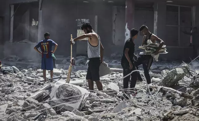 Palestinians inspect the damage after an Israeli army airstrike on a high-rise building in Gaza City, Friday, Sept. 5, 2025, after the Israeli army issued a prior warning. (AP Photo/Yousef Al Zanoun)