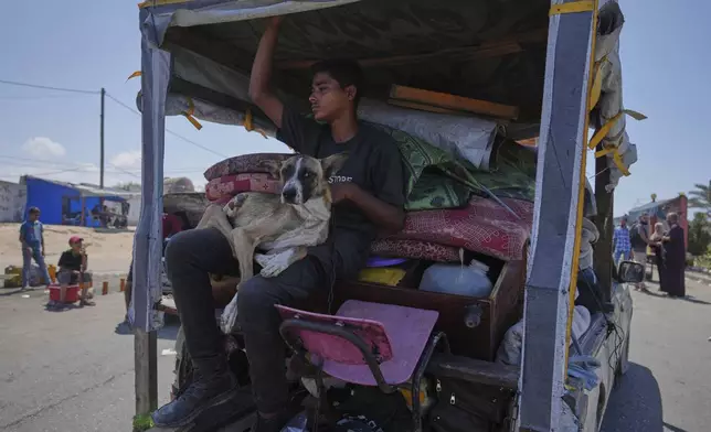 Displaced Palestinians fleeing northern Gaza carry their belongings along the coastal road toward southern Gaza, Tuesday, Sept. 9, 2025, after the Israeli army issued evacuation orders from Gaza City. (AP Photo/Jehad Alshrafi)