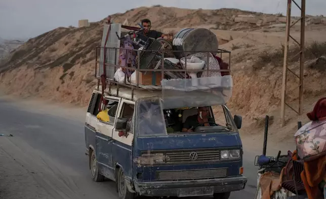 Displaced Palestinians fleeing northern Gaza carry their belongings along the coastal road toward southern Gaza ,Sunday, Sept. 7, 2025. (AP Photo/Jehad Alshrafi)