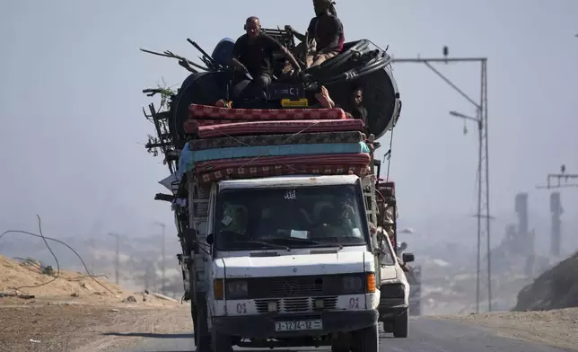 Displaced Palestinians fleeing northern Gaza carry their belongings in a car along the coastal road toward southern Gaza, Tuesday, Sept. 9, 2025, after the Israeli army issued evacuation orders from Gaza City. (AP Photo/Jehad Alshrafi)