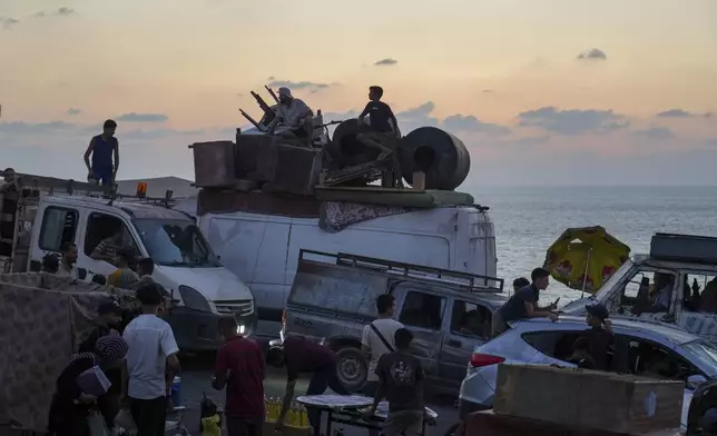 Displaced Palestinians fleeing northern Gaza carry their belongings along the coastal road toward southern Gaza ,Sunday, Sept. 7, 2025. (AP Photo/Jehad Alshrafi)
