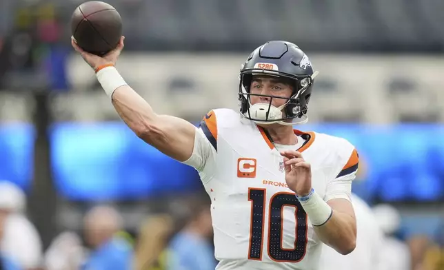 Denver Broncos quarterback Bo Nix warms up before an NFL football game against the Los Angeles Chargers, Sunday, Sept. 21, 2025, in Inglewood, Calif. (AP Photo/Gregory Bull)