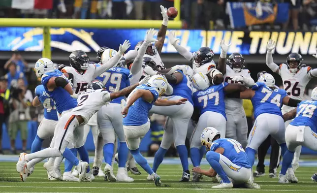 Los Angeles Chargers kicker Cameron Dicker (11) makes the game-winning field goal as time expires in an NFL football game against the Denver Broncos, Sunday, Sept. 21, 2025, in Inglewood, Calif. (AP Photo/Gregory Bull)