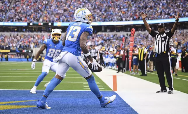 Los Angeles Chargers wide receiver Keenan Allen (13) celebrates his touchdown catch during the second half an NFL football game against the Denver Broncos, Sunday, Sept. 21, 2025, in Inglewood, Calif. (AP Photo/Carrie Giordano)