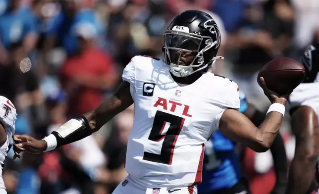 Atlanta Falcons quarterback Michael Penix Jr. passes against the Carolina Panthers during the first half of an NFL football game, Sunday, Sept. 21, 2025, in Charlotte, N.C. (AP Photo/Jacob Kupferman)
