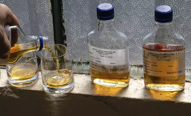 Danny Kahn, Master Distiller and Distillation/Aging Operations Director at Sazerac, Buffalo Trace's parent company, pours samples of bourbon from barrels that were exposed to floodwaters at Buffalo Trace Distillery on Sept. 16, 2025, in Frankfort, Ky. (AP Photo/Jon Cherry)