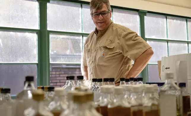 Danny Kahn, Master Distiller and Distillation/Aging Operations Director at Sazerac, Buffalo Trace's parent company, looks at bottles in the lab at Buffalo Trace Distillery on Sept. 16, 2025, in Frankfort, Ky. (AP Photo/Jon Cherry)