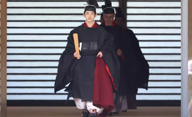 Japanese Prince Hisahito, son of Crown Prince Akishino, wearing ancient ceremonial costume, leaves for a ceremony by a carriage at the Imperial Palace in Tokyo Saturday, Sept. 6, 2025 as he celebrated his 19th birthday and attended the coming-of-age ceremony at the palace. (Yoshikazu Tsuno/Pool Photo via AP)